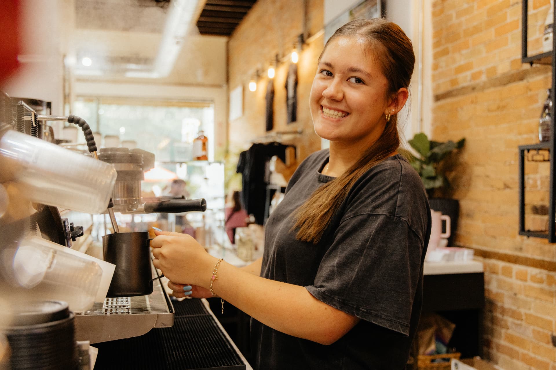 A barista steaming milk at the espresso bar